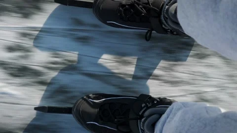 Top view of man legs are skating on thick ice on river in winter. Vertical video Stock Footage 284955209