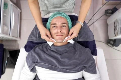 Top view of a man lying down on a stretcher ready for a facial beauty treatment Stock Photos