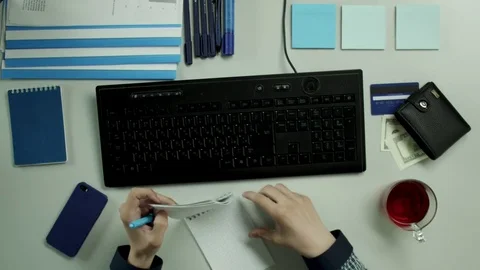 Top view of of a man marking important information Stock Footage 79987914