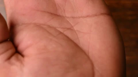 Top View of Man Open Palm Hand on Wooden Table – Front Side View Video Stock Footage 329353396