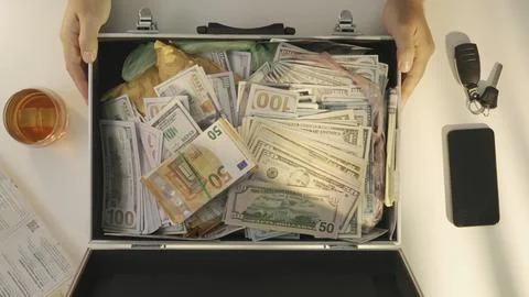 Top view of man opens suitcase full of euro dollar currency cash money banknotes Stock Photos