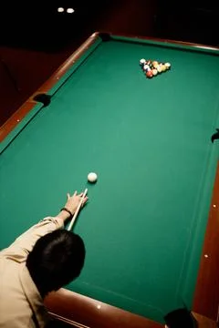 Top View of Man Playing Pool at Table Nd Hitting Ball with Cue Stick Stock Photos