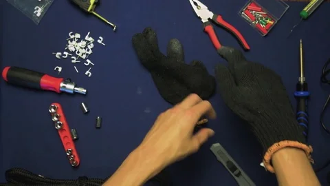 Top View Man Put on black gloves on hands, on the table are visible tools 動画素材 78996648