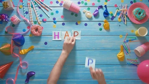 Top view man puts words Happy Birthday on the table with birthday decoration Stock Footage 74956800