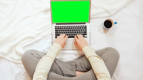 Top view man sitting on the bed typing on a laptop Stock Footage 120748900
