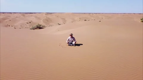 Top view of a man sitting on the sand. Stock Footage 165381642
