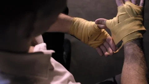 Top view of a man striking a protective sports tape on his arm Video stock 112941425