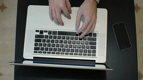 TOP VIEW - man typing on laptop computer Stock Footage 61633798