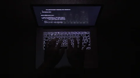 Top view of a man typing on a laptop in the dark Stock Footage 92525533