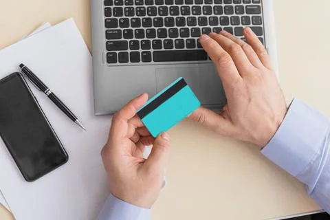 Top view of man using credit card for online shopping. E-commerce concept. Stock Photos
