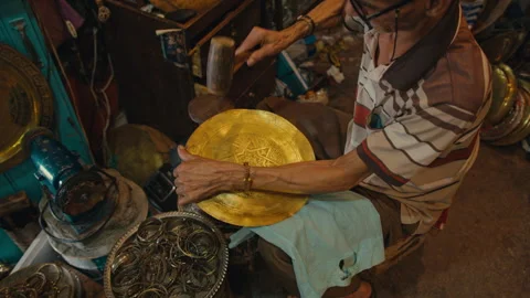 Top view of a man using a hammer on brassware Stock Footage 270453452