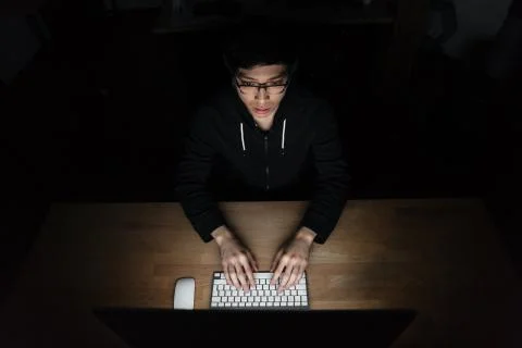 Top view of man using laptop in dark room 写真素材