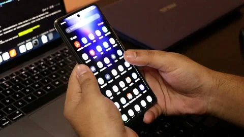 Top view of a man using smartphone while sitting at her working desk. Stock Footage 277843724