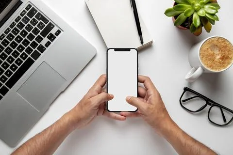 Top view man using smartphone with laptop coffee. High quality and resoluti.. Stock Photos