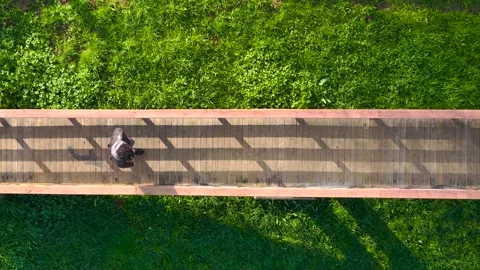 Top View Of A Man Walking Across Wooden Bridge Stock Footage 265439561