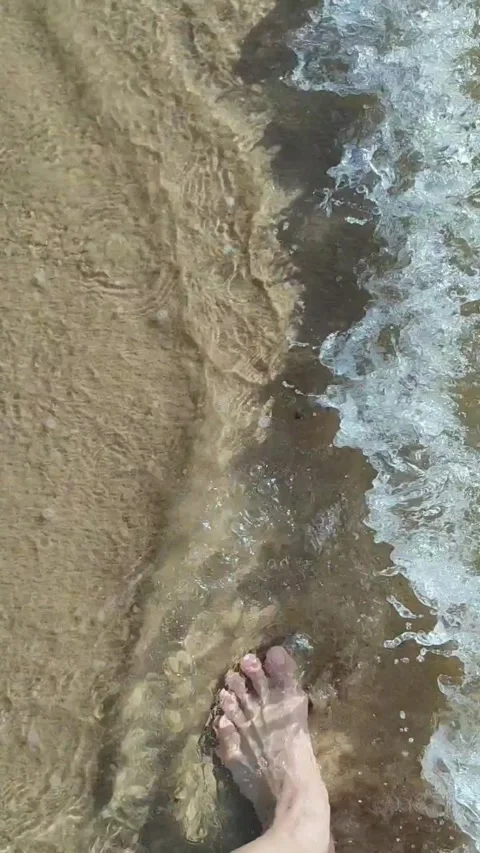 Top View: Man Walking on Beach Shore with Splashing Waves Stock Footage 310498244