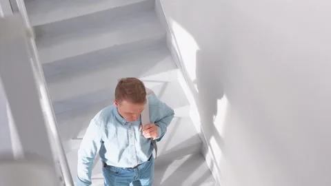 Top view of an  man walking up the stairs in a business center office. Stock Footage 306298079