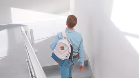 Top view of an  man walking up the stairs in a business center office. Stock Footage 306298092