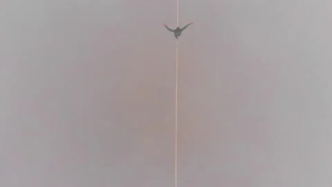 Top view of a man walking on a tight sling at a high altitude in the fog. Stock Footage 151228390