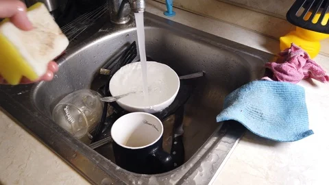 Top view of A man washes the dirty dishes in his kitchen Stock Footage 117924051
