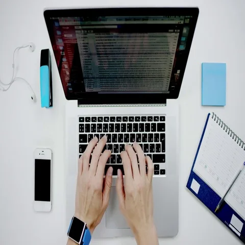 Top view of a man working with laptop and taking notes Stock Footage 69683195