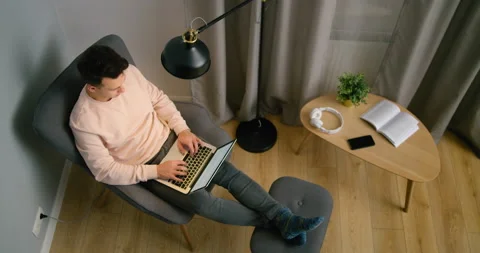 Top View of Man Working on Laptop at Home at Night. Male Student Studies Online Video stock 144791004