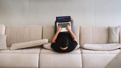Top View of a Man Working on a Laptop on a Sofa. Video stock 276979031