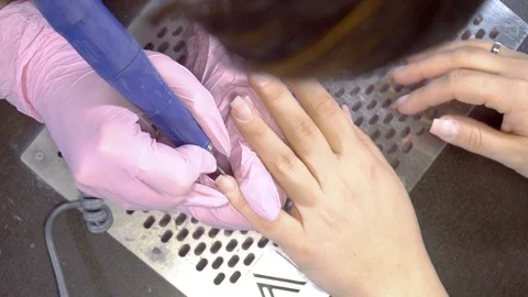 Top view manicurist remove cuticles using electric file nail drill Video stock 103339365