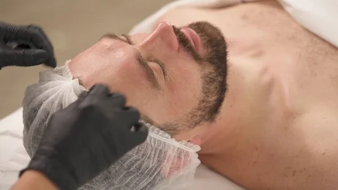 A top view of man's face in a cap and woman's hands in black gloves Stock Footage 101194973