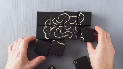 Top view on man's hand connecting wooden blocks iinto abstract human brain. Stock Footage 101874674