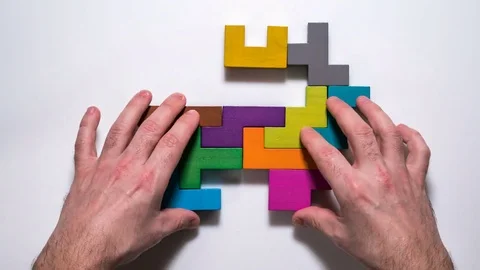 Top view on man's hand folding animals from colorful wooden blocks, timelapse. Stock Footage 84562508