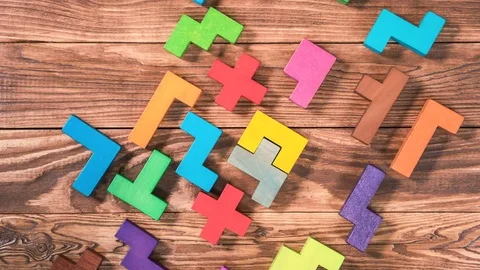 Top view on man's hand folding colorful wooden blocks on the white table. Stock Footage 85209458