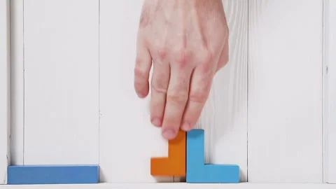 Top view on man's hand folding colorful wooden blocks. Stock Footage 88047486