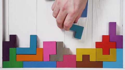 Top view on man's hand folding colorful wooden blocks. Stock Footage 88053315