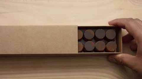 Top view of man's hand open a chocolate box Stock Footage 86287516