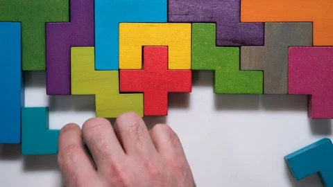 Top view on man's hand playing with colorful wooden blocks, timelapse. Stock Footage