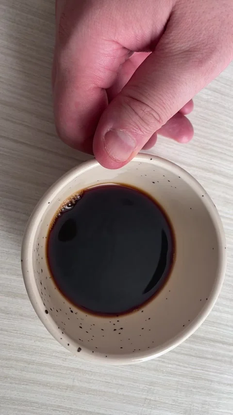 Top View of Man's Hand Taking a Ceramic Cup of Fresh Black Coffee Stock Footage 340214608