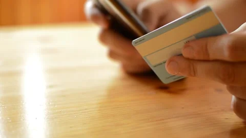 Top view man's hand using credit card for amazon shopping payment on phone. Stock Footage 206045826