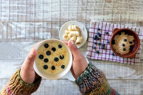 Top view a man's hands hold a bowl of yogurt and oatmeal a healthy breakfas.. Photos