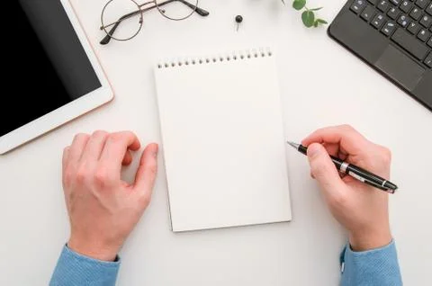 Top view man's hands with notepad on office desk. Workplace with notebook Stock Photos