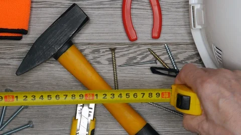Top View Of Man's Hands Putting Measuring Ruler On Wooden Background With Protec 스톡 동영상 128628048