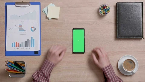 Top view of a man's hands touch the bottom right corner of a green screen on a Stock Footage 105513902