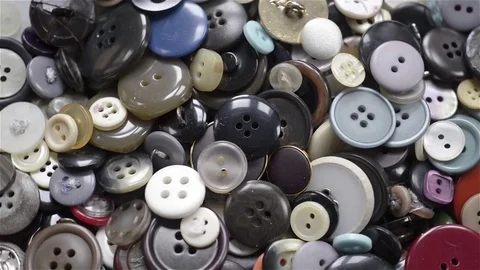 Top view of many buttons of different colors and shapes rotating. Stock Footage 72143585