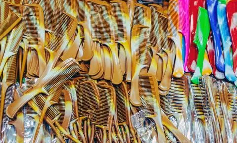 Top view of many cheap plastic comb for sale at the local market. Stock Photos