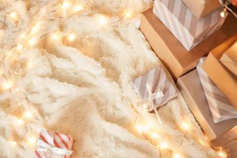 Top view of many present boxes on soft white carpet on floor decorated with g Foto stock