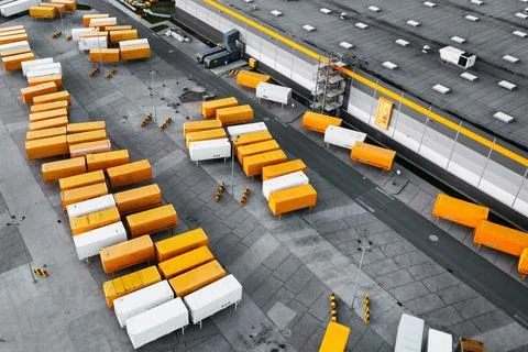 Top view of many trailers and containers near the logistics warehouse, in the Stock Photos