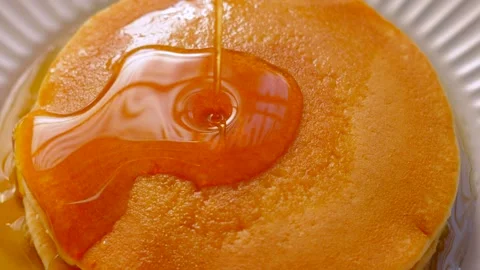 Top View of Maple Syrup Being Poured on Soft Buttermilk Pancakes. Stock Footage 337994063