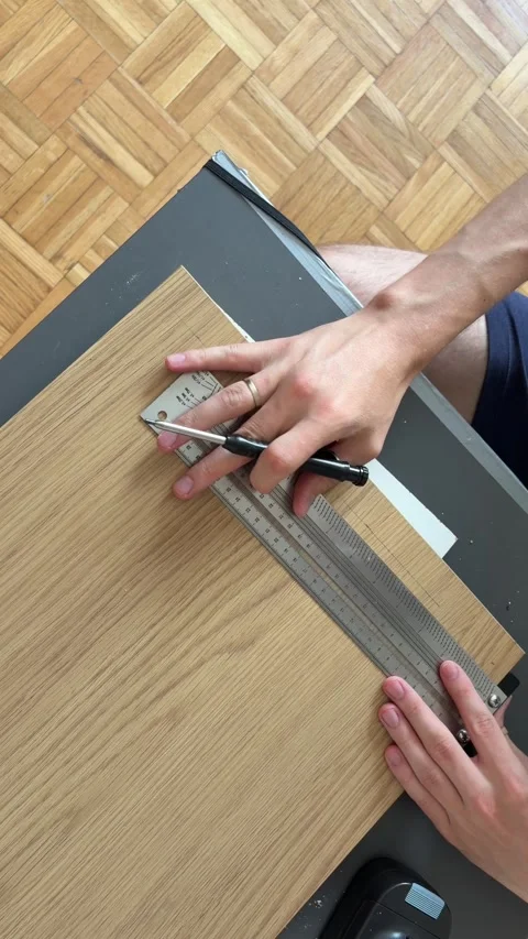 Top view of marking measured lines on wood panel for home furniture DIY project Stock Footage 341396662