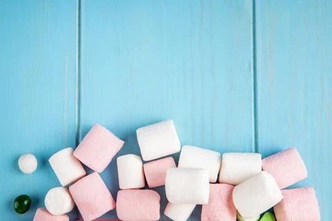 Top view of marshmallow on bottom on blue wooden background with copy space Stock Photos