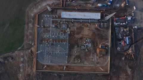 Top view on a massive construction site with people and heavy machinery, 4k Stock Footage 133559013